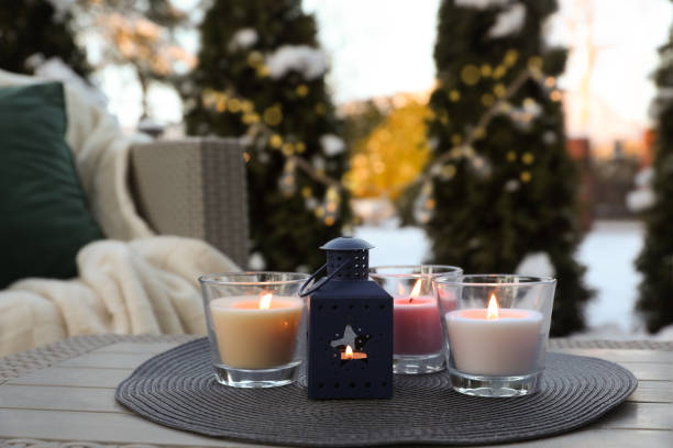 istock Beautiful burning candles and lantern on table outdoors. Cozy winter 1808196849