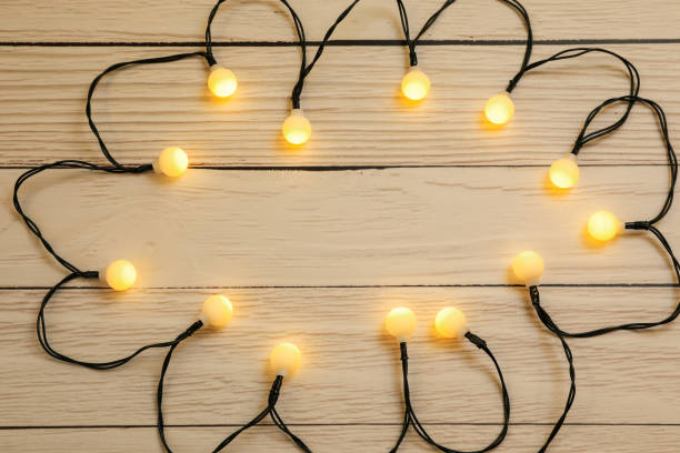 istock Glowing festive lights on wooden background, top view. Space for text 1808196852
