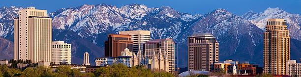 Salt Lake City Utah USA Skyline High Rise Mountain Panorama "A panorama of the Salt Lake City skyline at sunset. This is a high-resolution, Web Half Banner size image with an aspect ratio of 234a60 and shows many downtown landmarks including: the church office building of the Church of Jesus Christ of Latter-day Saints, the conference center, the Temple and Tabernacle, regional bank buildings, condominiums, and shopping centers.RELATED:" salt lake city mormon temple utah photos stock pictures, royalty-free photos & images