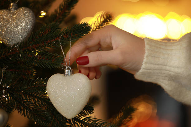 istock Woman decorating Christmas tree at home, closeup 1808198458