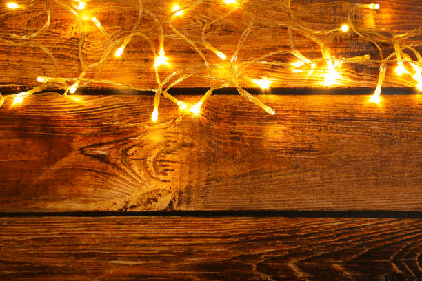 istock Glowing festive lights on wooden background, top view. Space for text 1808198465