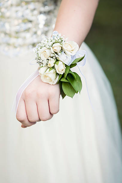 A white fabric floral arrangement with pearl centers created for a wedding.  Horizontal shot.