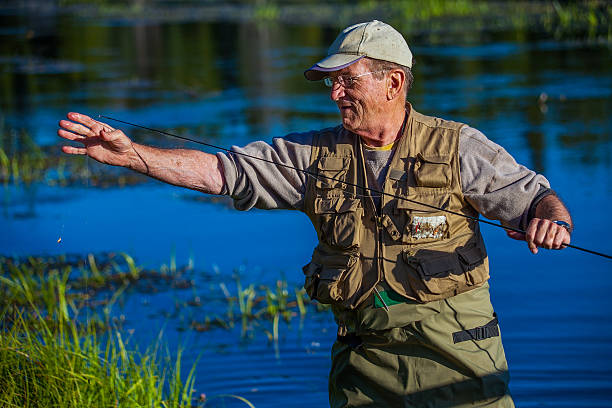 istock Fly Fisherman Readies Line 180820381