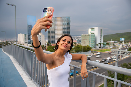 Empowered woman using cell phone in the city