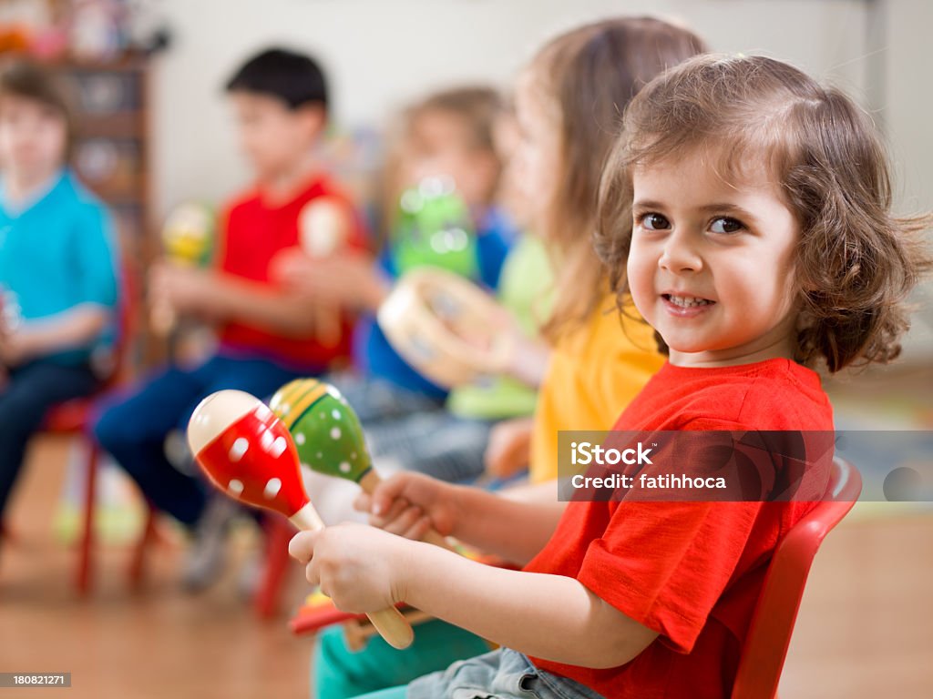 Music Class A group of preschool children in a music class.A little girl smiling at camera.  Child Stock Photo