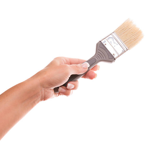 istock Paint brush in woman hand on white 180821596