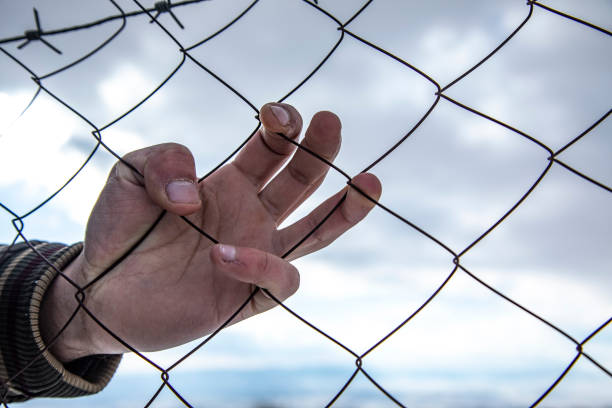 istock hand of a man in the cage 1808216612
