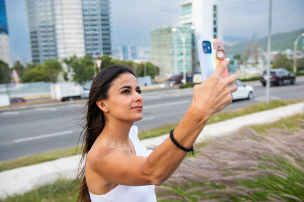 istock Woman using phone in a city 1808218647