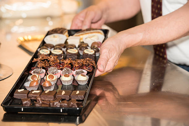 istock Baker is presenting a tray of various handmade chocolate pralines 180821867