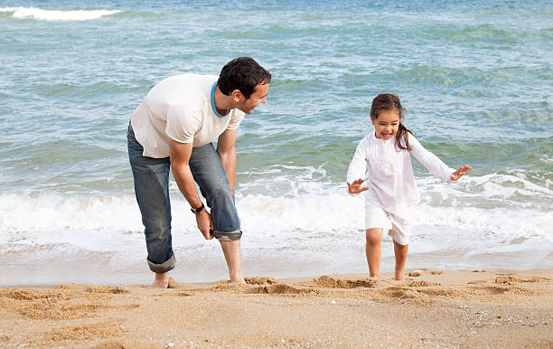 istock Father and daughter on the beach 180822117