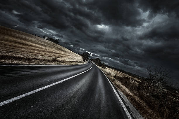 Way forward Asphalt road at storm. Forward direction. all weather running track stock pictures, royalty-free photos & images