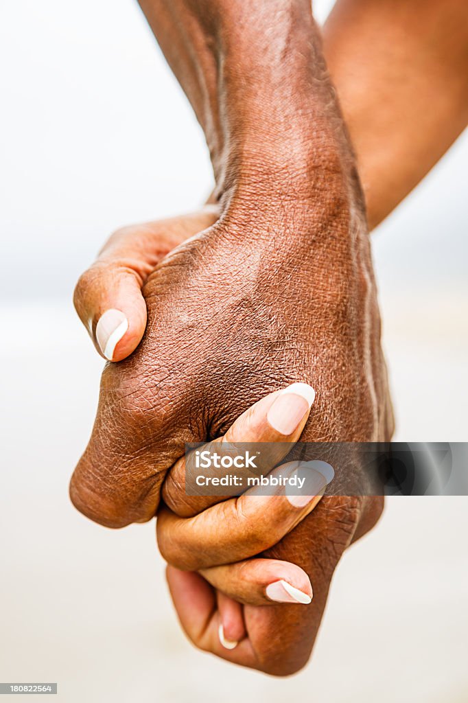 Senior African American couple holding hands Senior African American couple holding hands at beach. Model released. Click for more similar images from this session. Walking Stock Photo