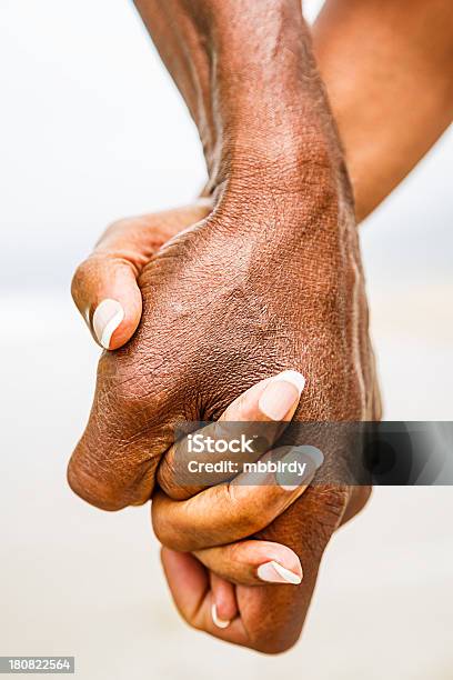 Senior African American Couple Holding Hands Stock Photo - Download Image Now - Walking, Beach, Holding Hands