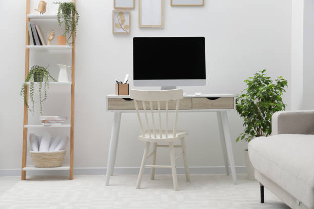 istock Spacious workspace with desk, chair, computer and potted plants at home 1808226268