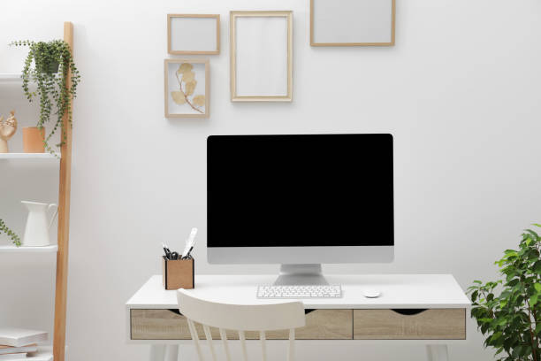 istock Cosy workspace with desk, chair, computer and plants at home 1808226466