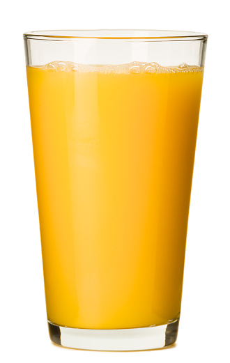 Tasty orange juice in glass and jug on white wooden table against blurred background. Space for text