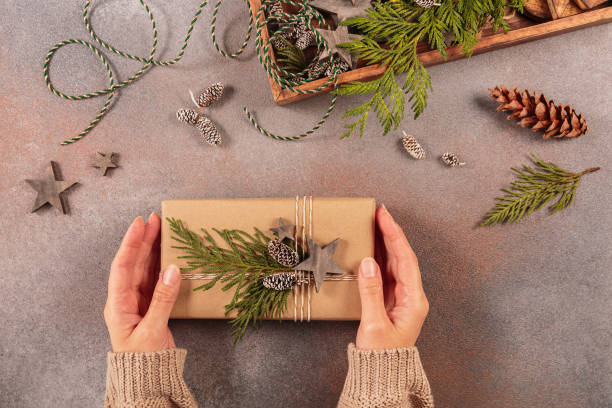istock Christmas decor and Womans hands decorating handmade gift box 1808231085