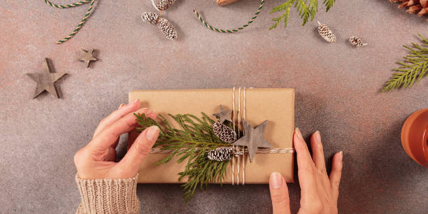 istock Christmas decor and Womans hands decorating handmade gift box 1808231086