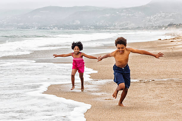 istock Playful Kids Running on The Beach 180823594