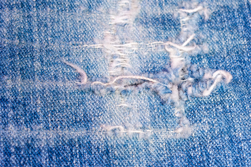 detail of a ripped jeans