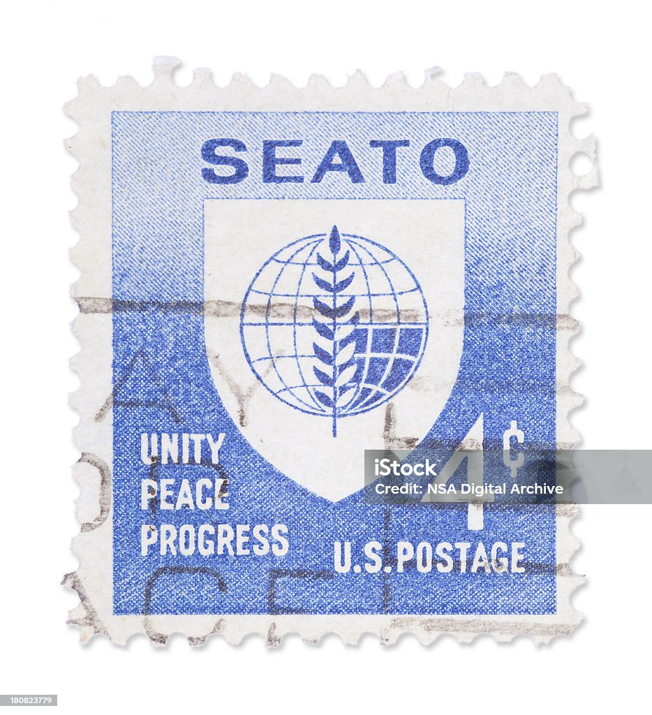 Vintage US stamp - SEATO Vintage US stamp with SEATO symbols. Isolated on white with light shadow. Canon 5D Mark II. Blue Stock Photo