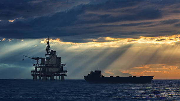 impianto di perforazione petrolifera sul mare con la nave cisterna in arrivo - petroliera nave cisterna foto e immagini stock