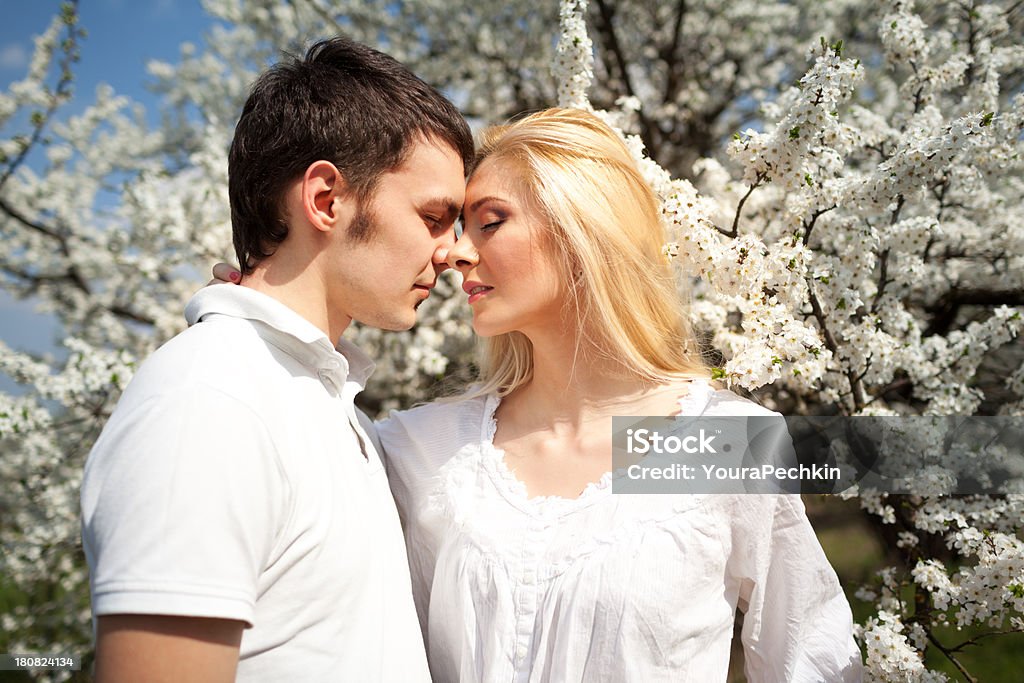 Loving couple Loving couple on the blossom background 20-24 Years Stock Photo