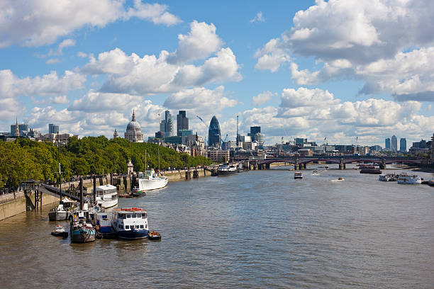 London, Great Britain View along the River Thames. Waterloo Bridge and the financial district in the background. waterloo bridge stock pictures, royalty-free photos & images
