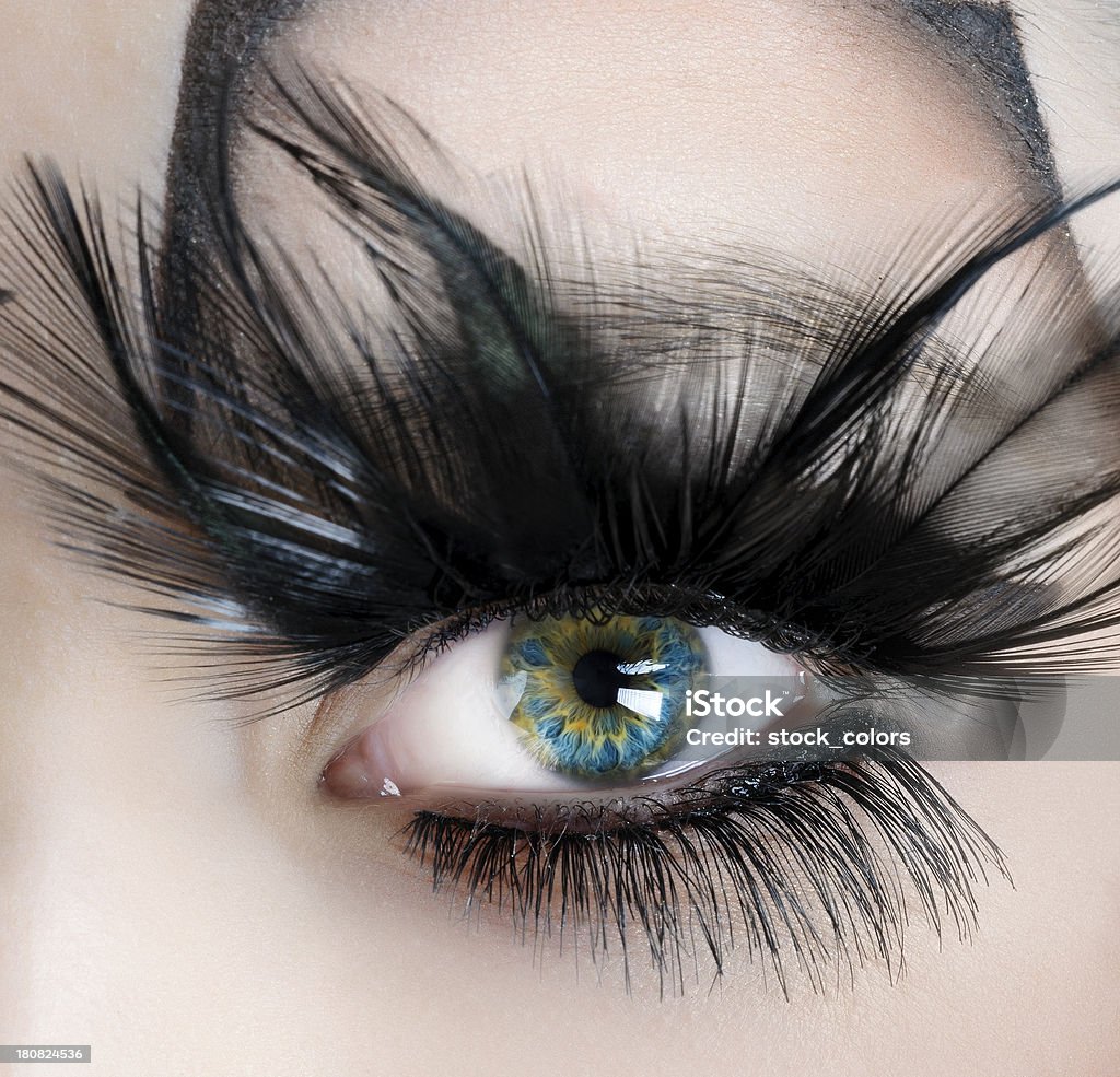 turquoise eye woman with green and turquoise eye, feather eyelashes. Black Color Stock Photo