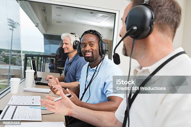 Members Of Media Reporting On Sports Game In Press Box Stock Photo - Download Image Now