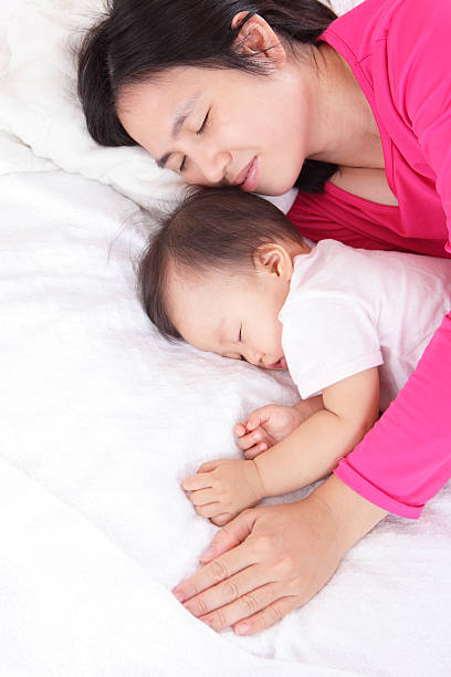 istock Young mother look her sleeping baby 180824739