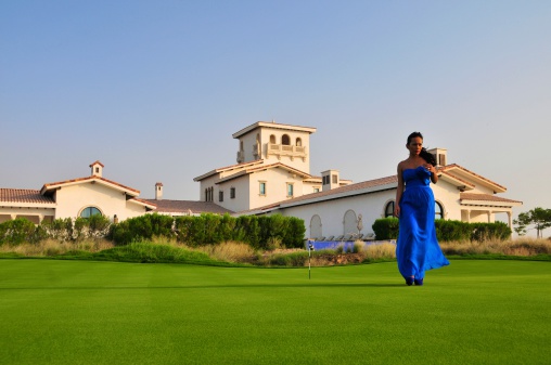 A beautiful Asian model at Yas Links golf course on Yas Island, Abu Dhabi, UAE