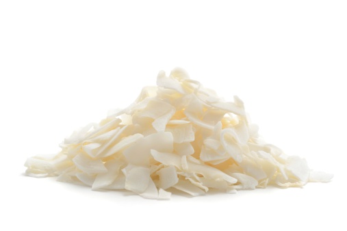 A small heap of dessicated coconut flakes isolated on a white background.