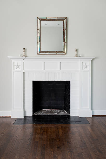 Wood fireplace with a nautical them in living room.