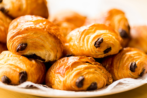 Pile of freshly baked croissants filled with chocolate