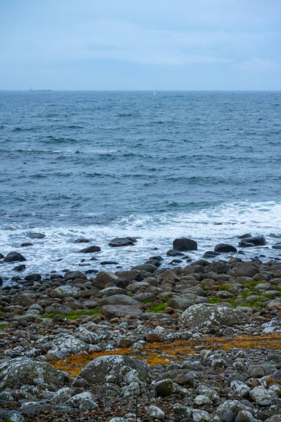Stone beach in rough sea.