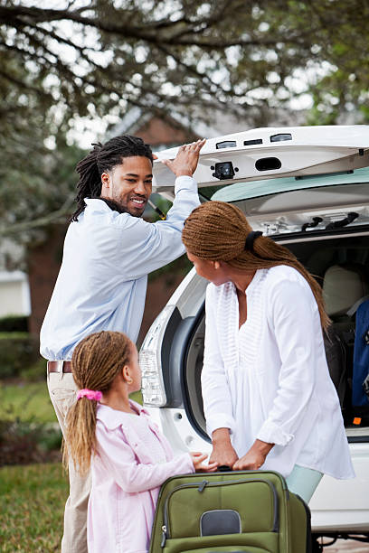 istock Family loading luggage into car 180824947