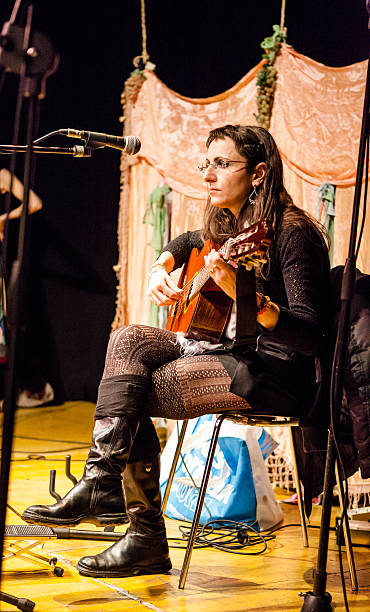 istock Woman Singing with Guitar 180825236