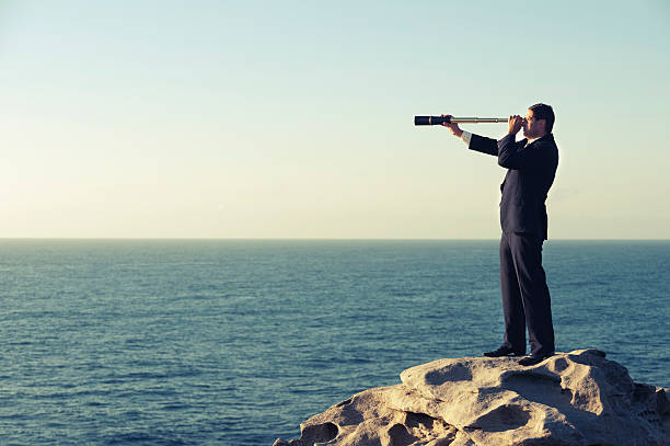 istock Businessman looking to the future with telescope 180826094
