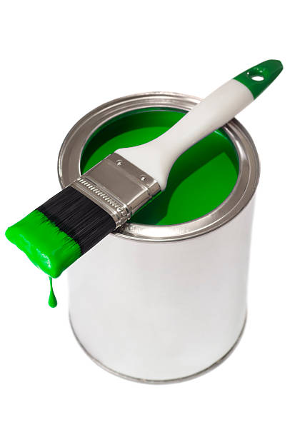 istock green dripping paint brush on a tin of paint 180826112