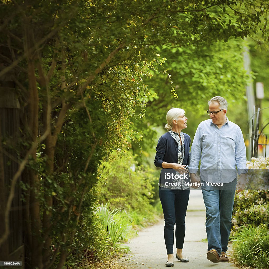 Coppia matura su una passeggiata - Foto stock royalty-free di Abbigliamento casual