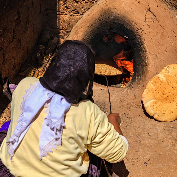 istock Moroccan woman making bread - khubz 180826862