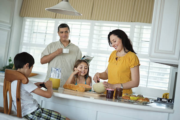 istock Woman Preparing Breakfast With Family In Kitchen 180827003