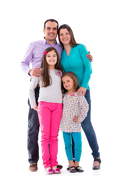 istock Family of four with two daughters smiling facing camera 180827032