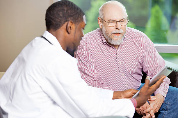 istock Doctor explaining treatment to a senior man on digital tablet 180827122