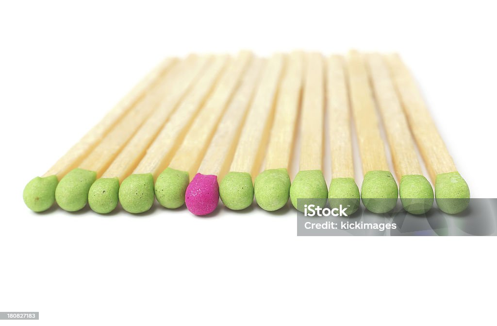 Extraordinary "Close-up of one red color matchstick among many green color matchsticks in a row, isolated on white background." Awe Stock Photo