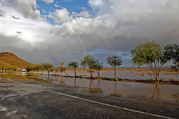 arcobaleno con molta strada in marocco africa settentrionale - mini van ecosystem dramatic sky meteorology foto e immagini stock