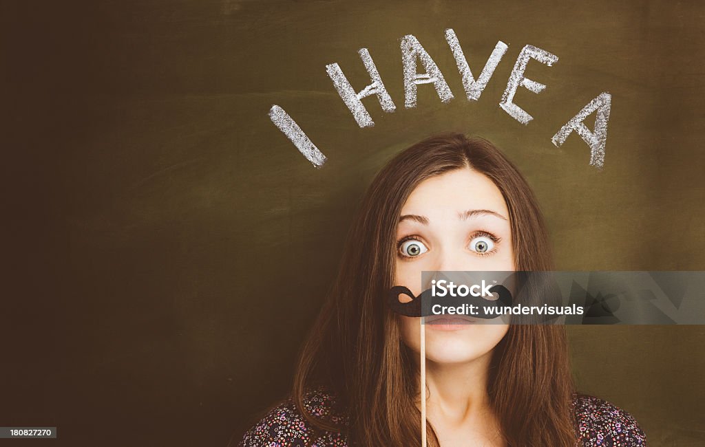 i have a mustache Hipster girl with mustache, near blackboard. Adult Stock Photo