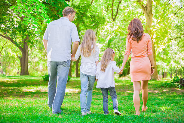 istock Happy family walking in the park 180827539