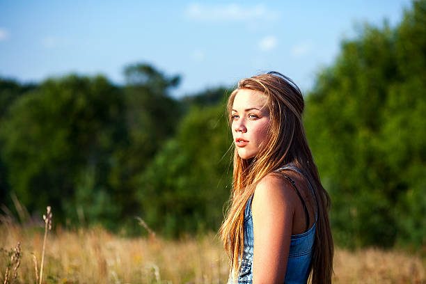 istock beautiful  woman in  field 180827559